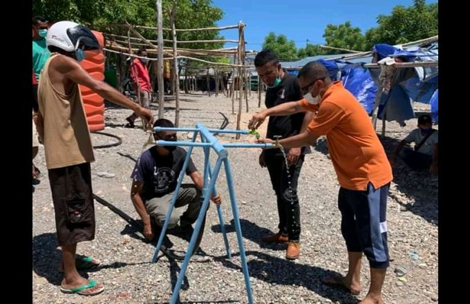 Xefe Gabinete Interinu PA ba RAEOA, Agustinho Caet akompaña ho nia ekipa sira monta hela bee moos iha merkadu Numbei, Oe-Kusi Ambeno hodi fasilita komunidade sira tenke fase liman molok tama ba merkadu laran. Foto Oe-Kusi Post/Abilio Elo Nini