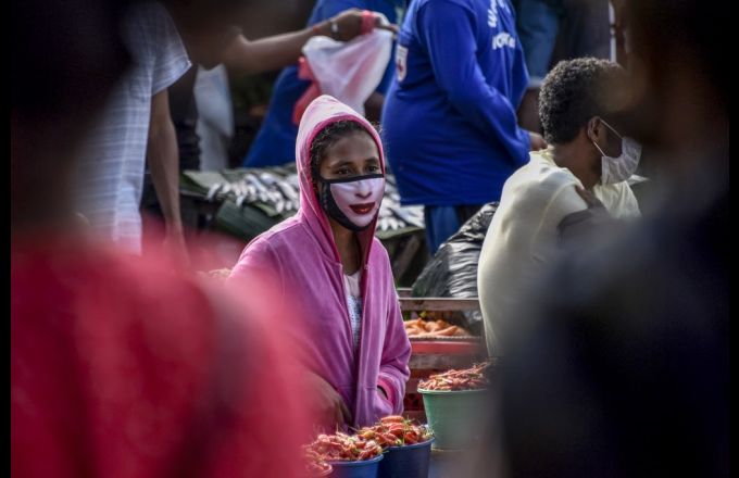 A vegetable vendor wears a face mask during the Covid-19 pandemic in Dili, Timor-Leste on April 16, 2020. Credit: VALENTINO DARIELL DE SOUSA / AFP